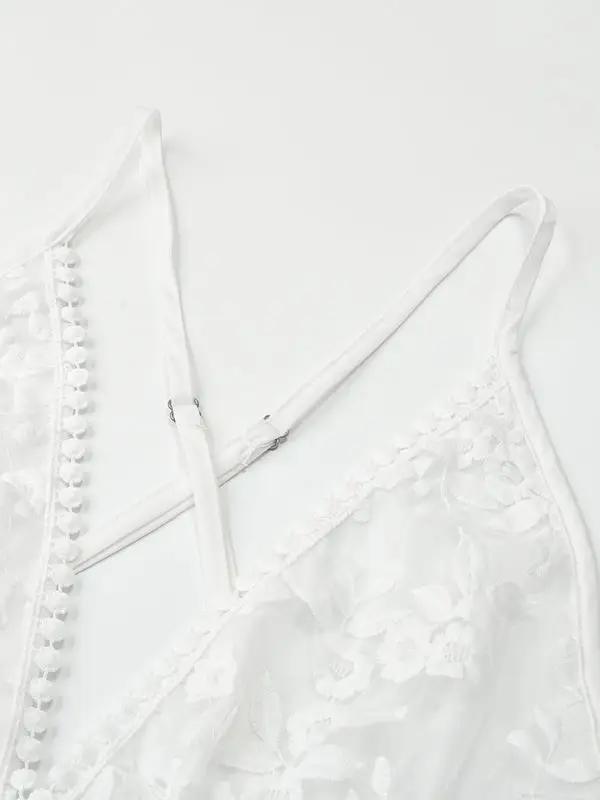 Strap and lace detail of white beach dress