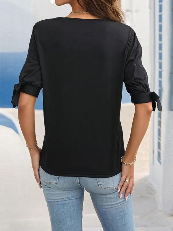 Back view of black top with hollow shoulders and bows