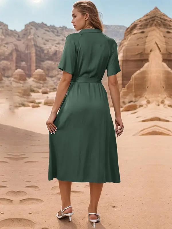 Back view of woman in green lapel dress in desert.