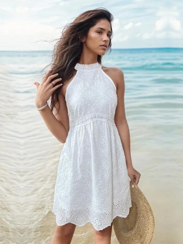 Elegant white halterneck dress by the sea