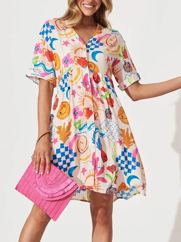 Model wearing colorful loose holiday dress with pink clutch