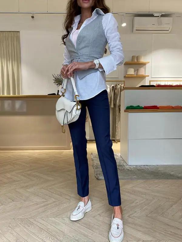 Gray vest over white shirt with navy pants