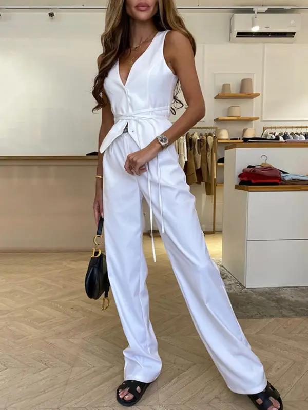 Full view of white lace-up vest and pants outfit