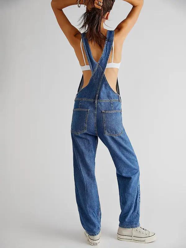 Back view of blue denim overalls with open back