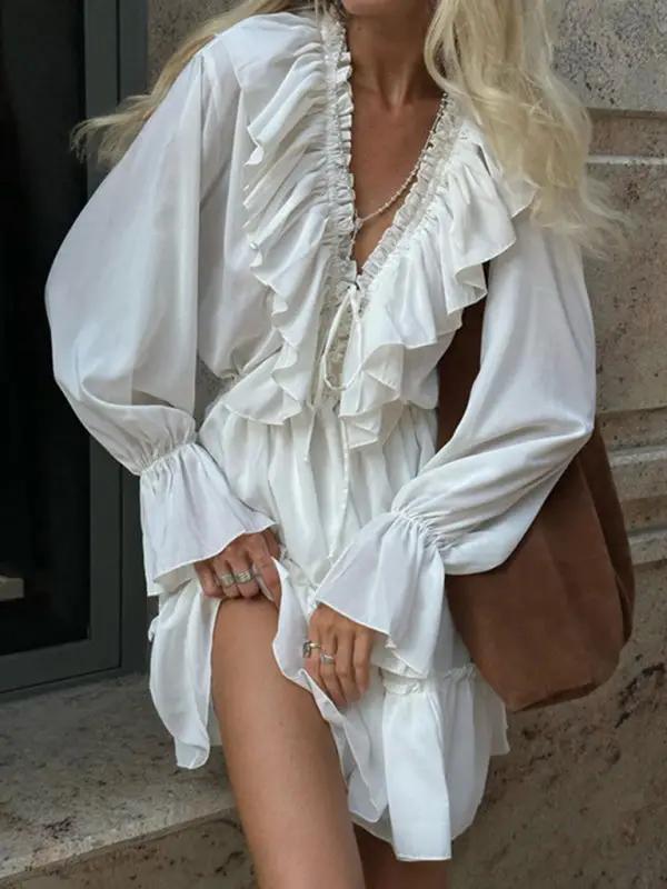 White dress with deep V-neck and ruffled trumpet sleeves