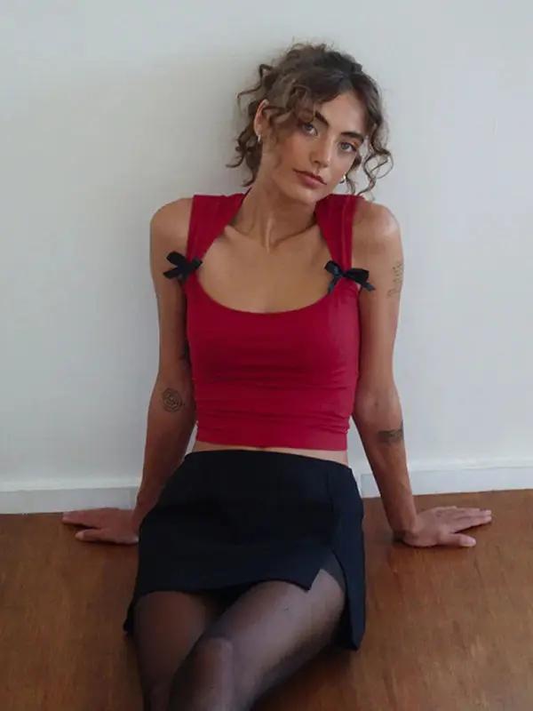 Red vest with bows, seated pose