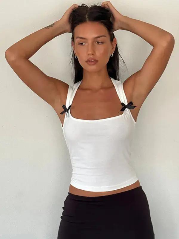 White vest with bow decoration, arms raised