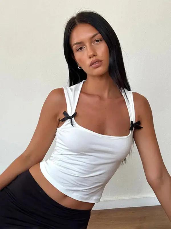 White vest with bows, seated pose