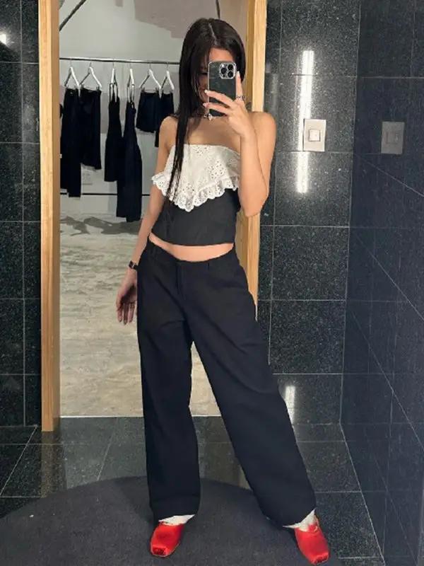 Model in crochet tube top vest with black pants
