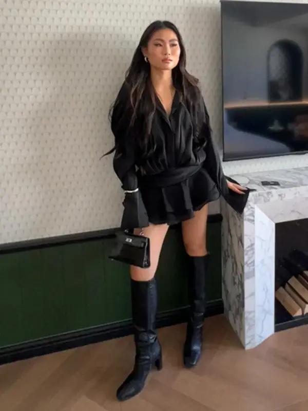 Black V-neck shirt dress with knee-high boots