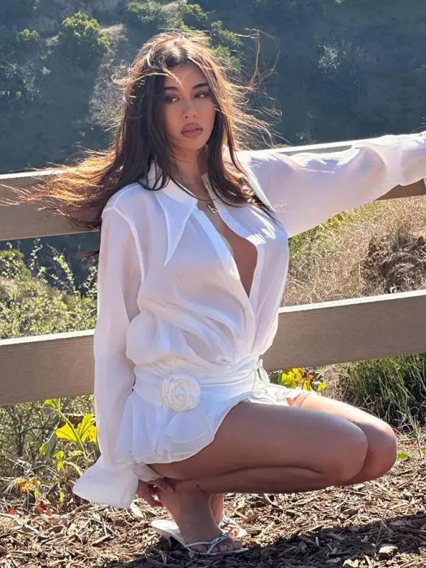 White V-neck shirt dress with floral detail outdoors