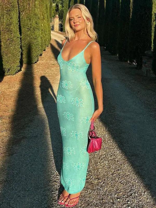Green floral suspender dress in sunlit pathway