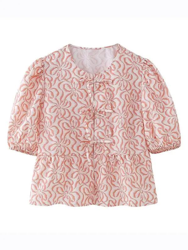Pink patterned puff sleeve lace-up top, front view