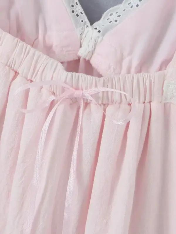 Close-up of pink lace dress with ribbon detail