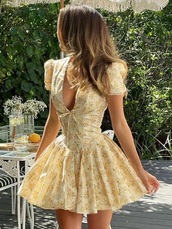 Back view of floral dress with deep V and pleats