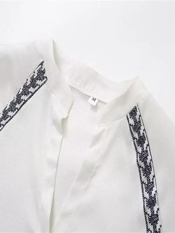 Neckline and cross-stitch detail of white shirt