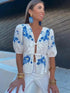 Model wearing floral print V-neck blouse with bow detail