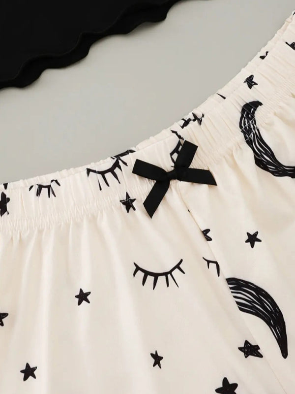 Close-up of star moon print shorts with bow detail