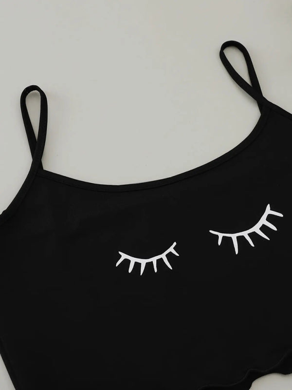 Eyelash print detail on black camisole top