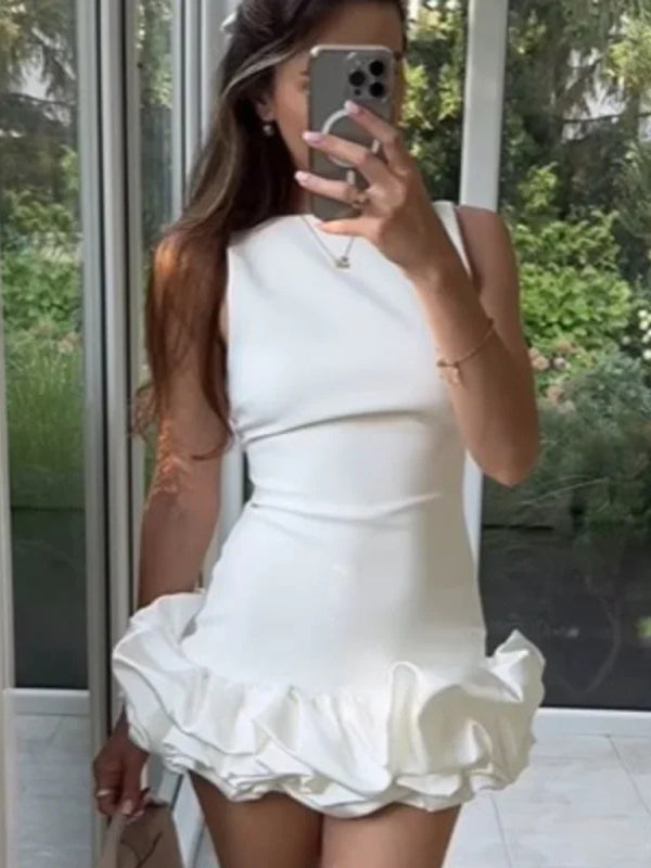 Selfie of model in white sleeveless short ruffle dress