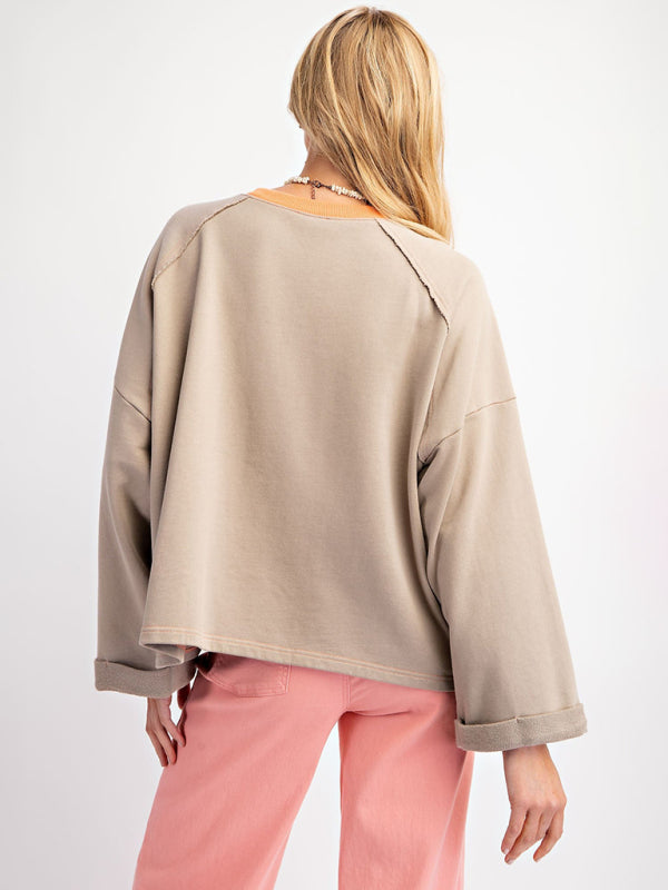 Gray floral patch top with pink pants, back view