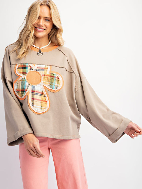 Gray floral patch top with pink pants, front view