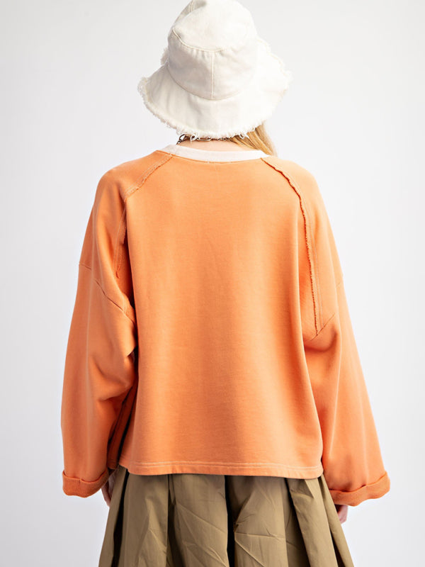 Orange floral patch top with khaki skirt, back view