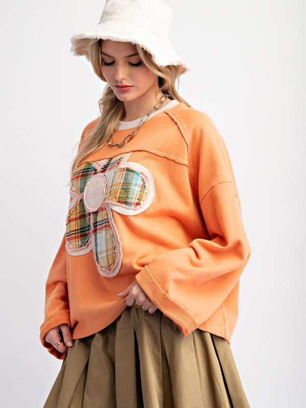 Orange floral patch top with khaki skirt, side view