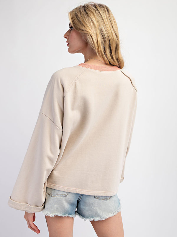 Beige floral patch top with denim shorts, back view