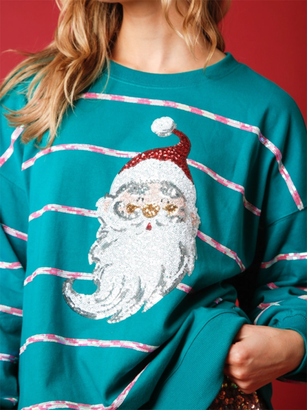 Close-up of Santa Claus sequin design on teal sweatshirt.