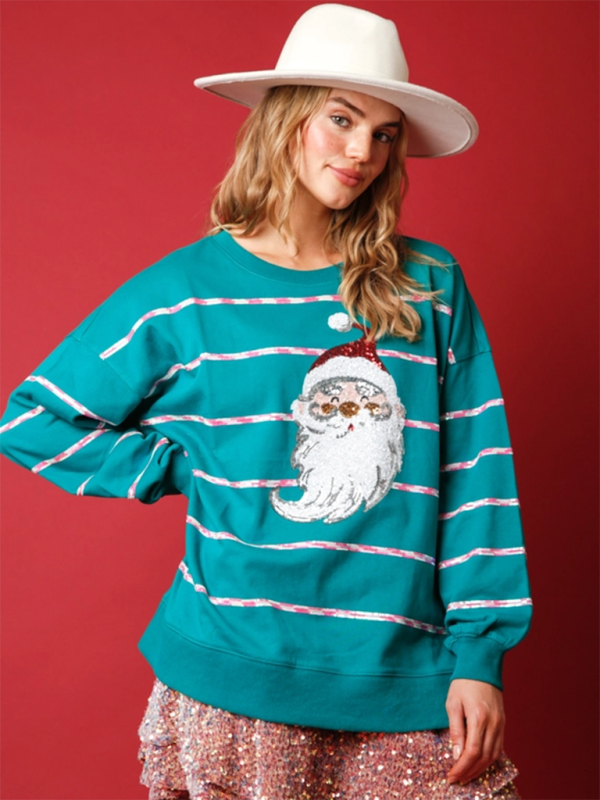 Model wearing teal Santa Claus sequin sweatshirt, smiling.