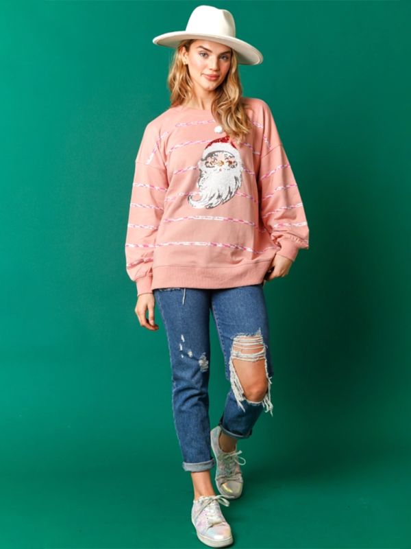 Full view of pink Santa Claus sequin sweatshirt with jeans.