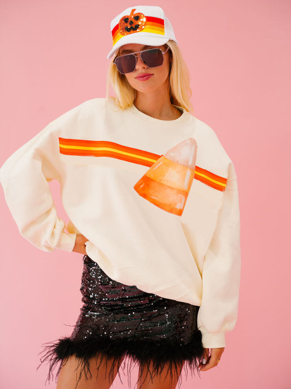 Model in cream candy corn sweatshirt, Halloween casual look