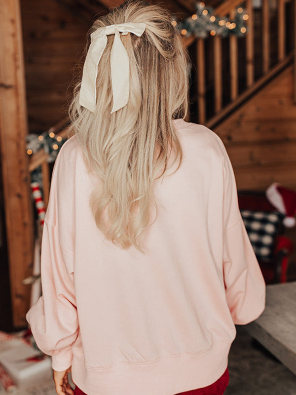 Back view of pink sweatshirt with hair ribbon