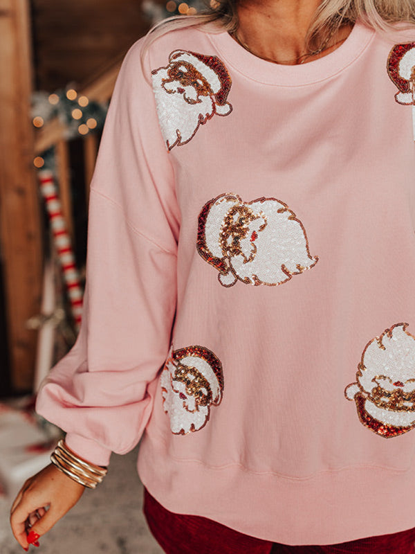 Close-up of pink sweatshirt with Santa sequin design