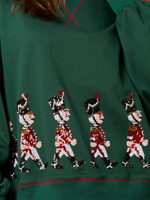Close-up of sequin soldier design on green sweatshirt