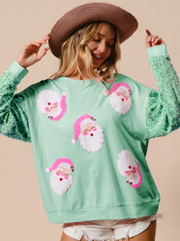 Green sweater with Santa faces and sequin sleeves
