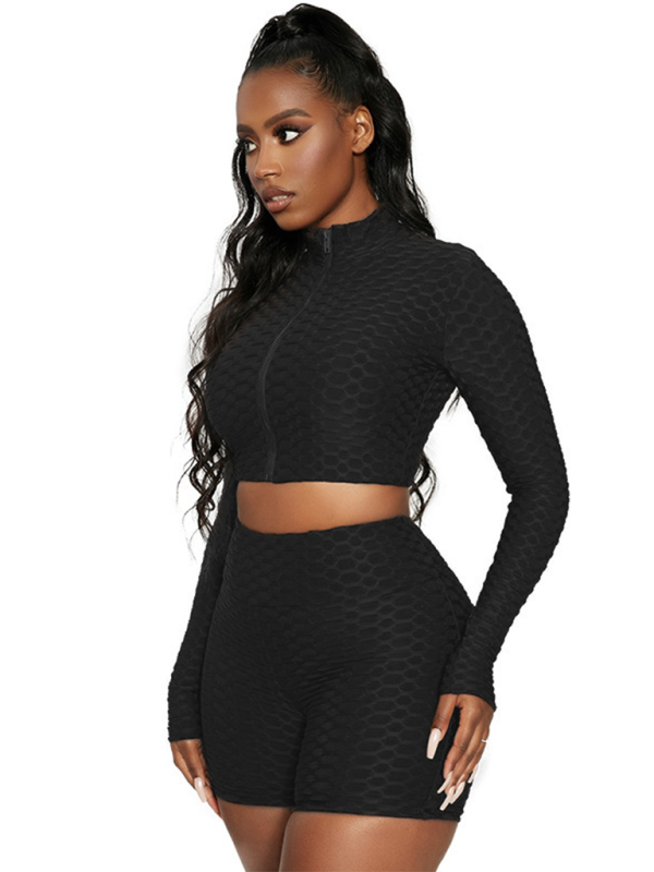 Side view of black textured athleisure set with long sleeves