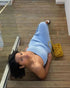 Blue tube top tight skirt, woman lying on wooden floor