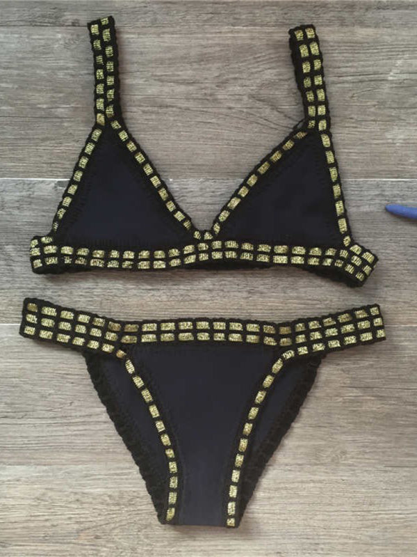 a bikini top that is laying on a wooden floor