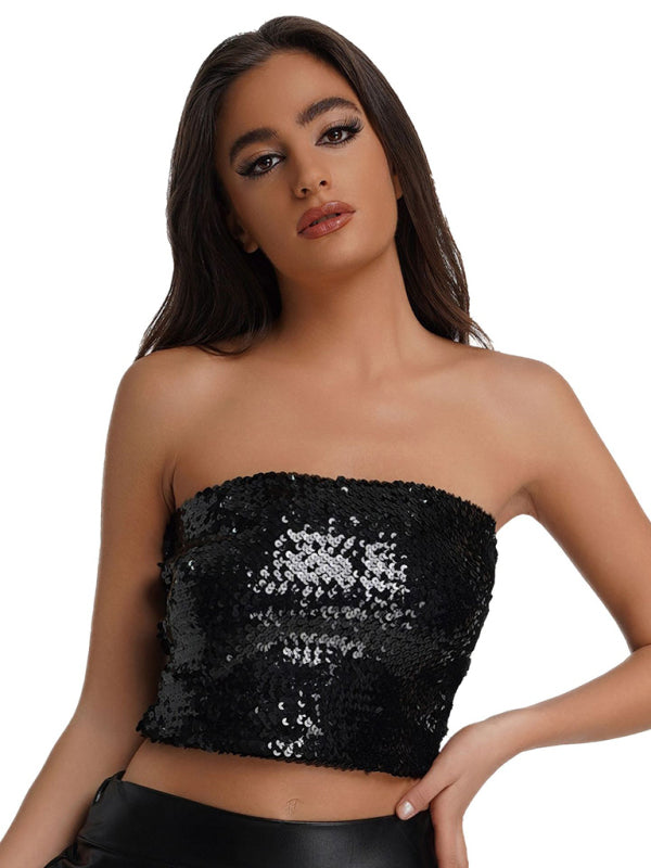 a woman wearing a black top with sequins