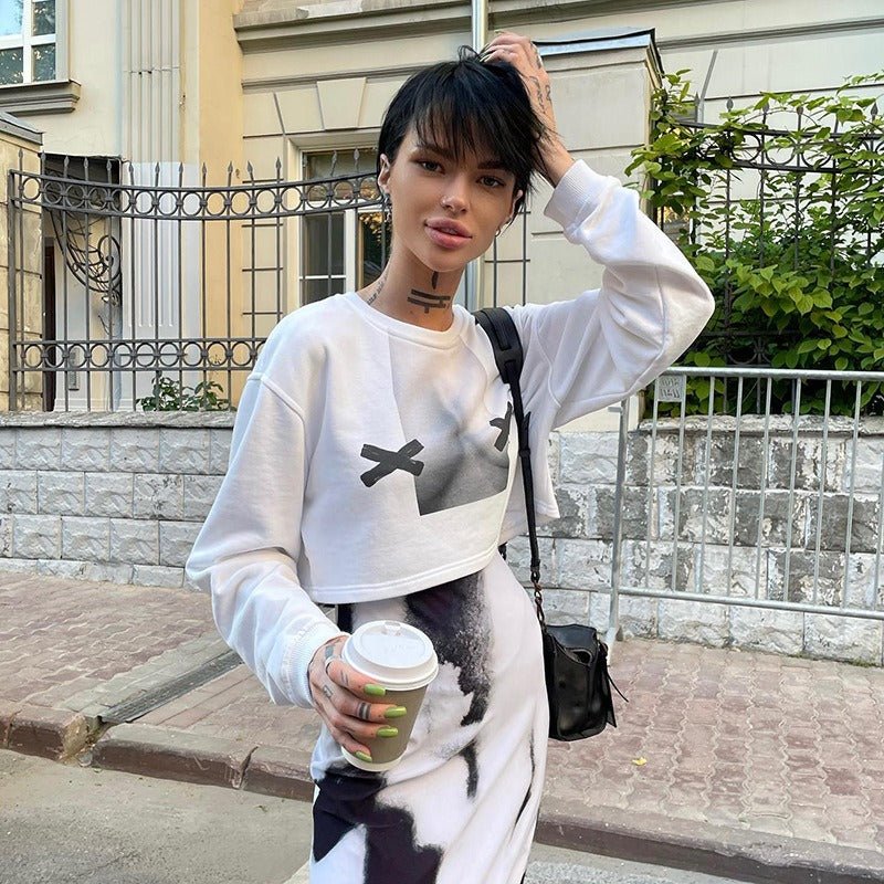 a woman with black hair and a white shirt is holding a cup of coffee