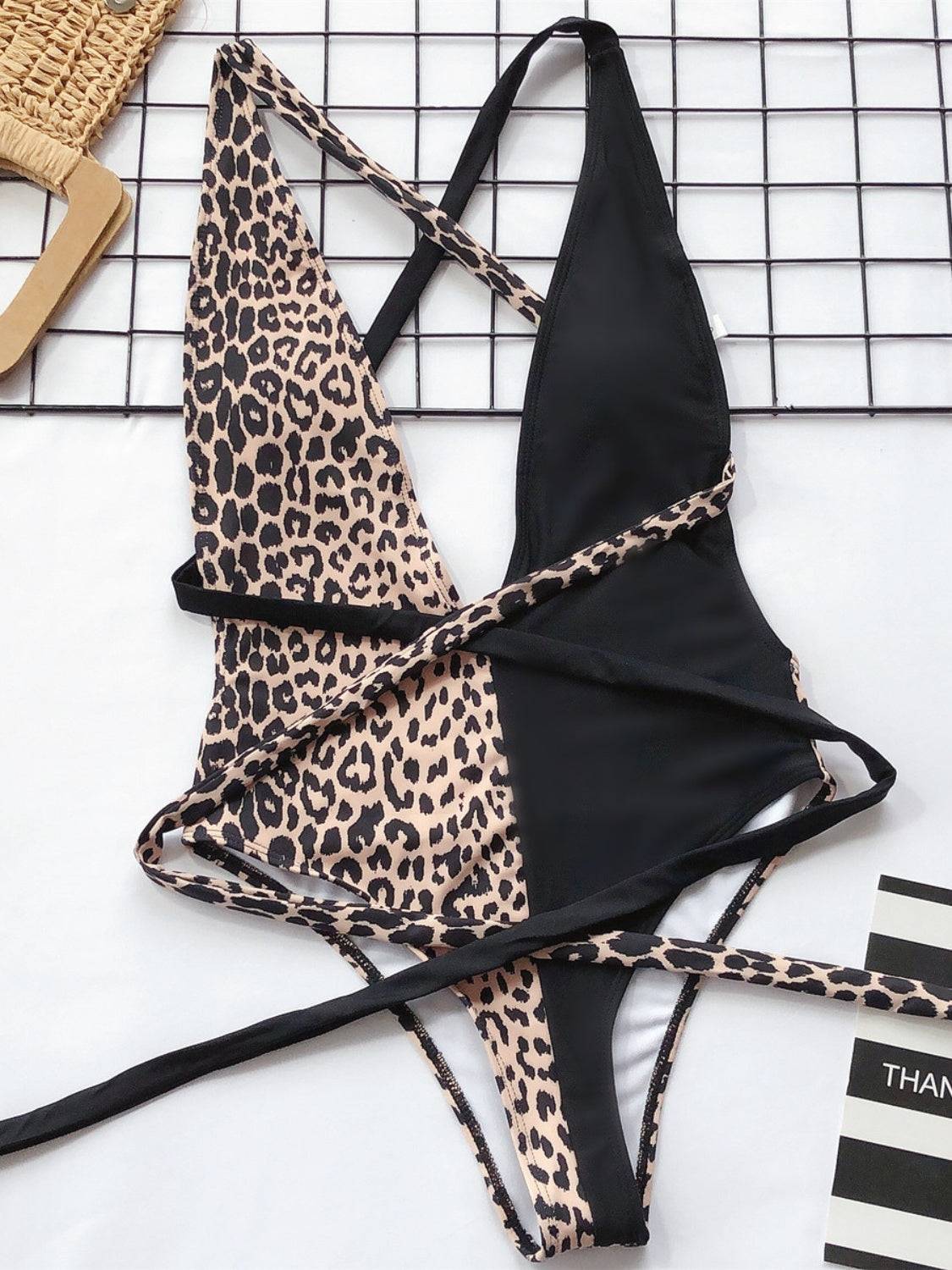 Flat lay of black and leopard plunge swimwear