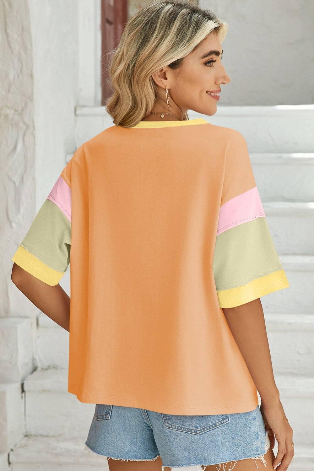 Back view of orange color block round neck t-shirt