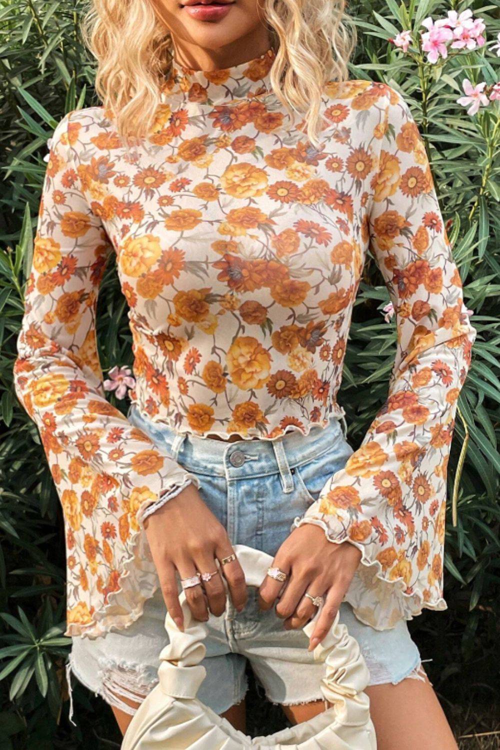 Model wearing floral mock neck flare sleeve top