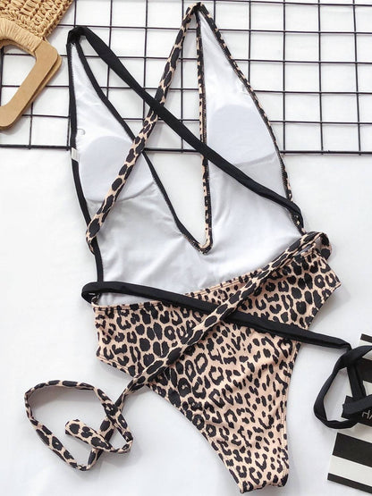 Flat lay of leopard and black one-piece swimwear