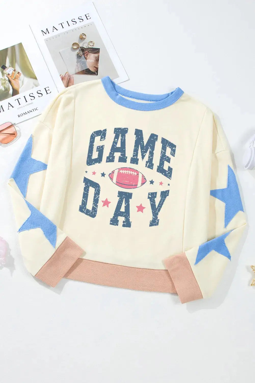 Flat lay of GAME DAY star patch sweatshirt