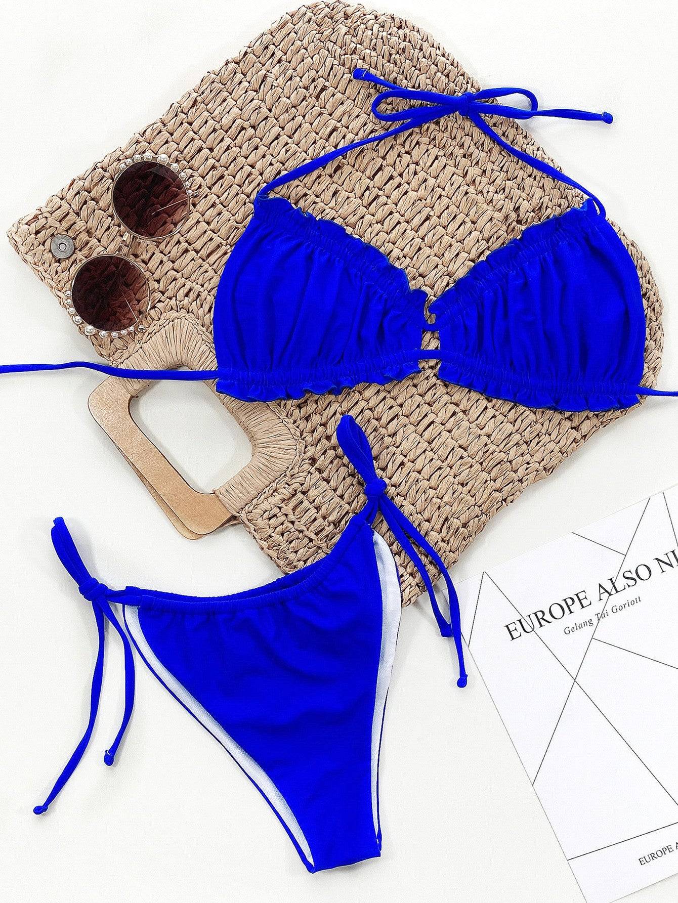 Blue bikini set displayed with accessories