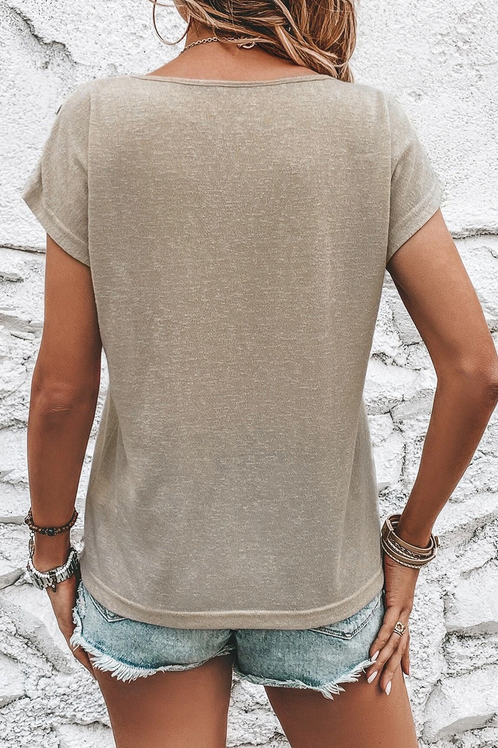 Plain back view of short sleeve t-shirt with button details