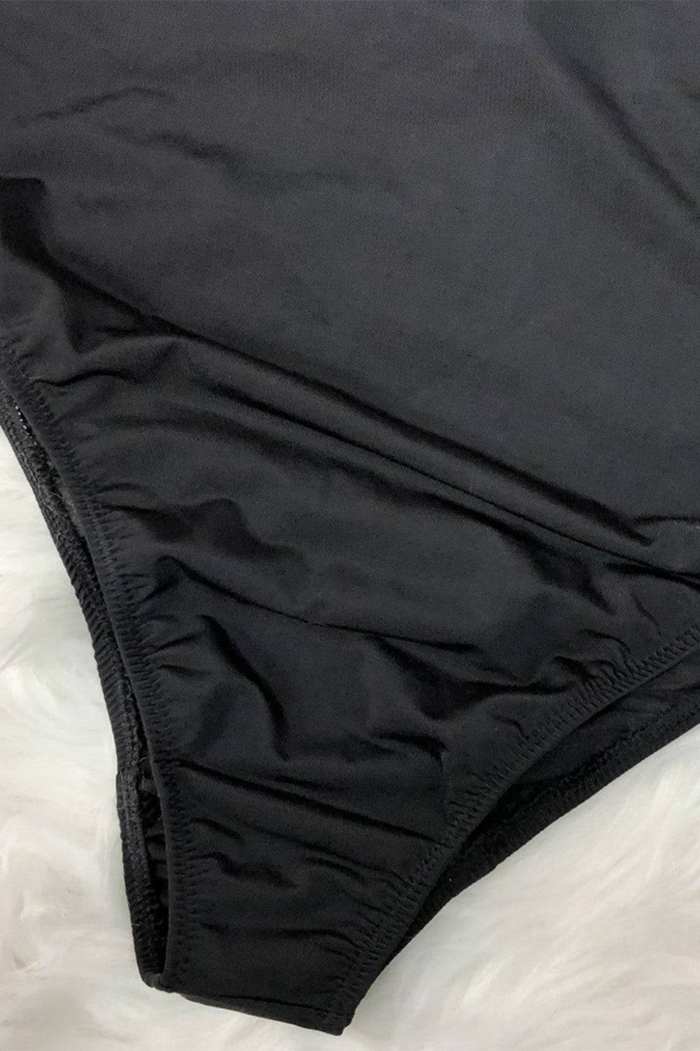 Close-up of black one-piece swimwear fabric detail